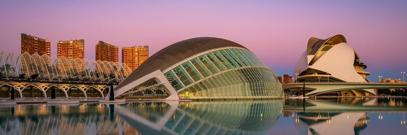 The City of Arts and Sciences in Valencia, reflected in its pool at dusk.
